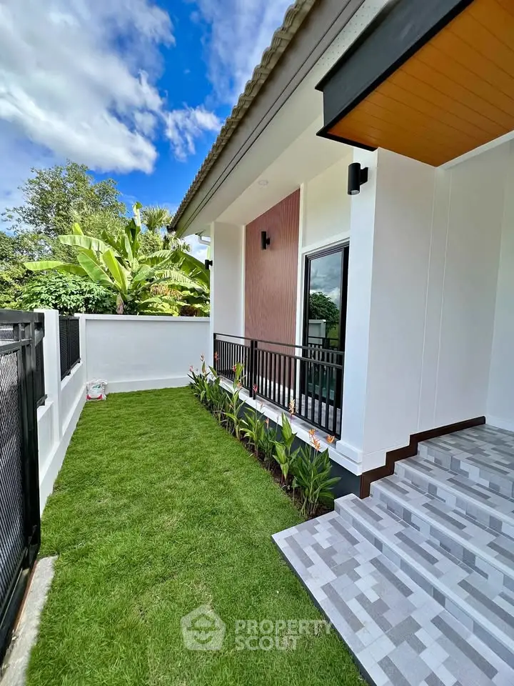 Modern home exterior with lush garden and stylish entrance steps