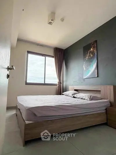 Modern bedroom with large window and stylish decor