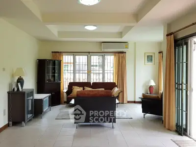 Spacious living room with modern furniture and large windows for natural light.