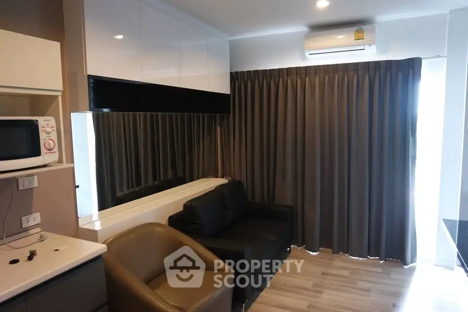 Modern living room with sleek furniture and air conditioning in a stylish apartment.