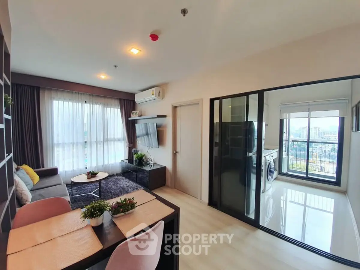 Modern living room with balcony view and stylish decor in a contemporary apartment.