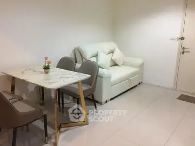 Modern living room with elegant marble dining table and cozy white sofa, perfect for stylish urban living.