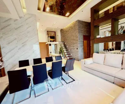 Luxurious modern living room with elegant dining area and stylish staircase in upscale apartment.