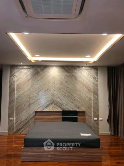 Modern bedroom with stylish wood paneling and ambient lighting