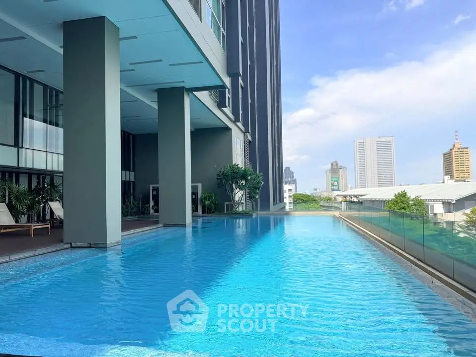 Luxurious high-rise building with stunning rooftop pool and city views.
