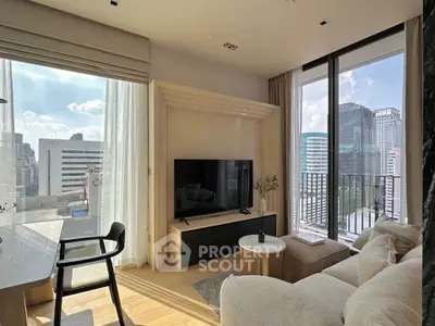 Modern living room with city view, large windows, and stylish furniture in high-rise apartment.