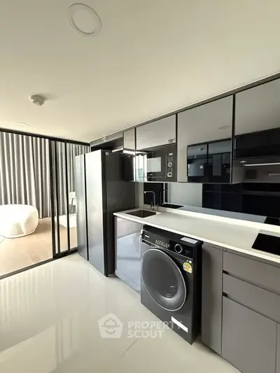 Modern kitchen with sleek appliances and open layout in luxury apartment.