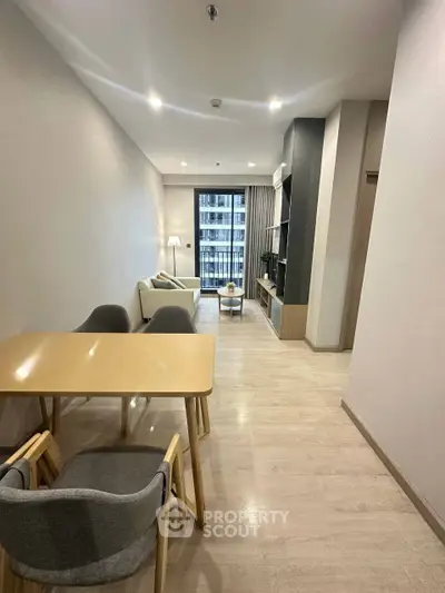 Modern living room with stylish furniture and balcony view in a contemporary apartment.
