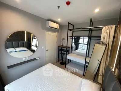 Modern bedroom with loft bed, mirror, and workspace in stylish apartment