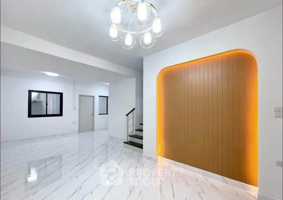 Modern interior with elegant lighting and sleek marble flooring in a spacious living area.