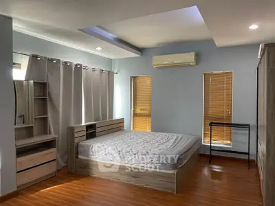 Spacious bedroom with modern wooden furniture and natural light