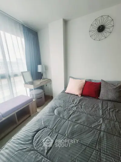 Modern bedroom with stylish decor and large window for natural light