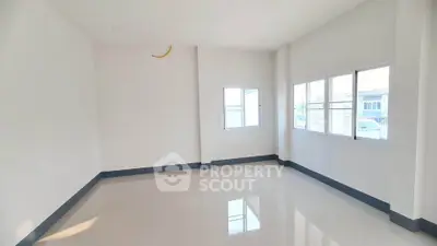 Spacious empty room with large windows and glossy tiled floor, perfect for customization.