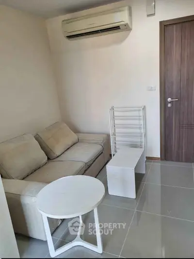 Cozy living room with modern air conditioning and minimalist furniture.