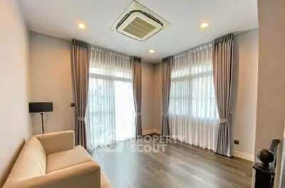 Spacious living room with elegant curtains and modern ceiling air conditioning.