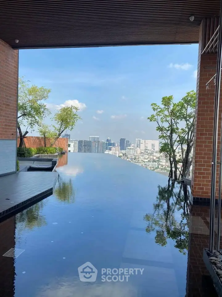 Luxurious rooftop infinity pool with stunning city skyline view, perfect for relaxation and leisure.