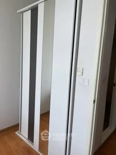 Modern sliding closet doors in a sleek bedroom setting.