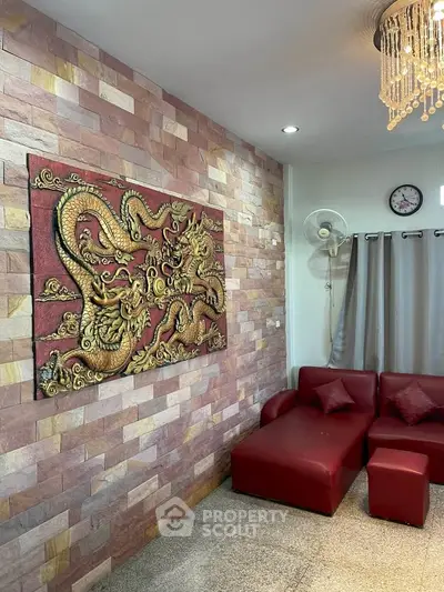 Stylish living room with red leather sofa and dragon wall art, perfect for modern home decor.