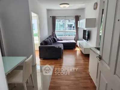Modern living room with sleek furniture and natural light, perfect for cozy gatherings.