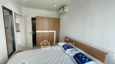 Modern bedroom with air conditioning and sleek wooden wardrobe in a minimalist design.