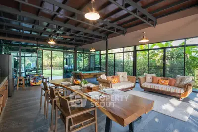 Stunning open-plan living room with modern design and lush garden views.