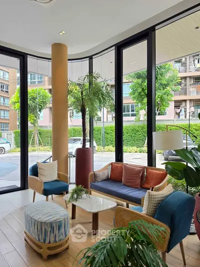 Stylish modern living room with large windows and cozy seating, perfect for relaxation and entertaining.