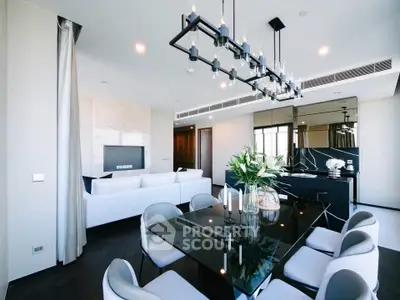 Luxurious modern living room with elegant dining area and stylish chandelier in a high-end apartment.