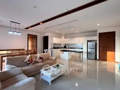 Spacious modern living room with open kitchen and elegant decor in a luxury apartment.