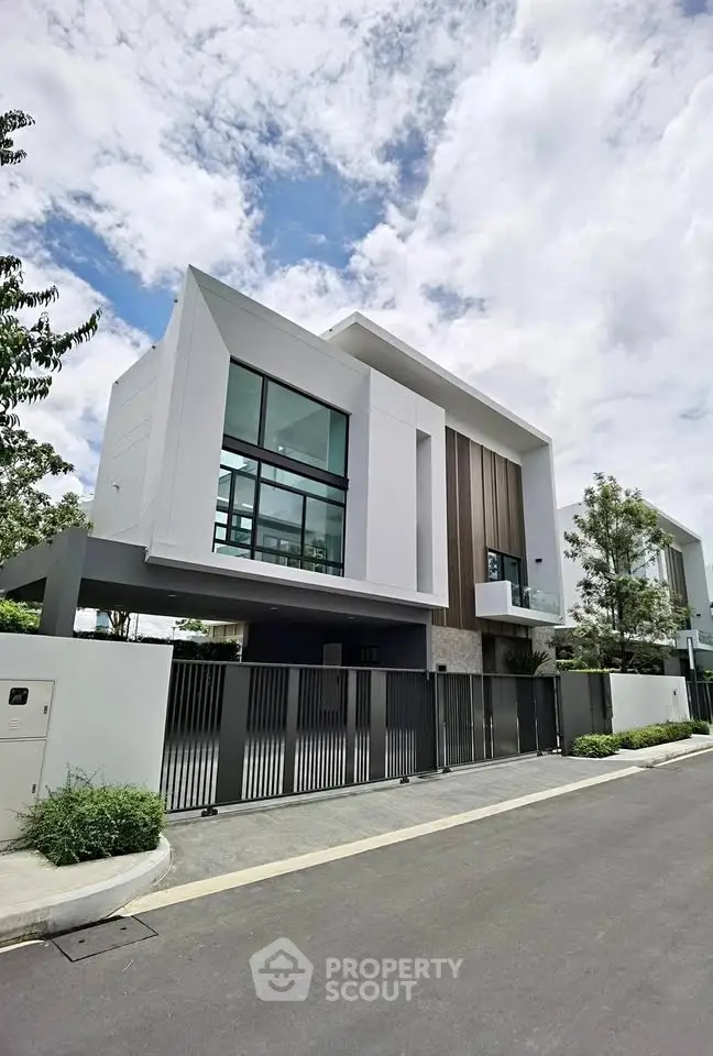 Modern architectural house with sleek design and large windows under a clear sky.