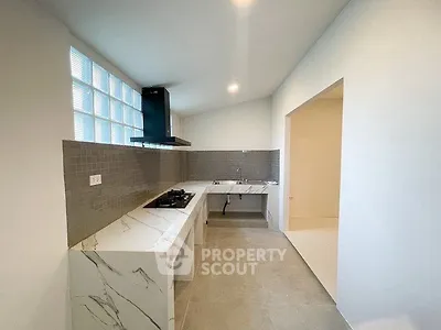 Modern kitchen with sleek marble countertops and gas stove