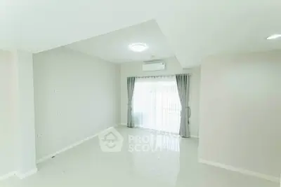 Spacious and bright living room with modern design and large window.