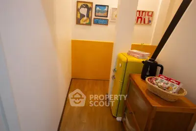 Charming small kitchen nook with retro yellow fridge and cozy decor.