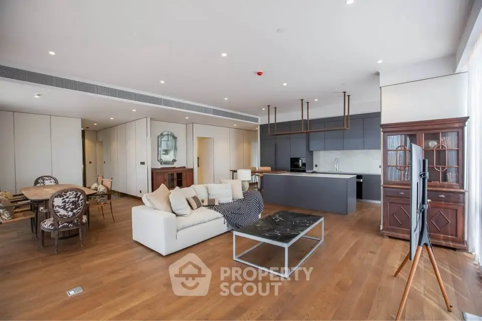 Spacious open-plan living room with modern kitchen and elegant decor