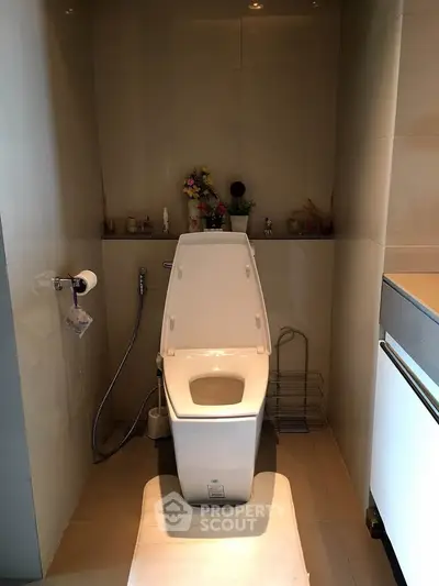 Modern bathroom with sleek toilet and minimalist design, perfect for contemporary living spaces.