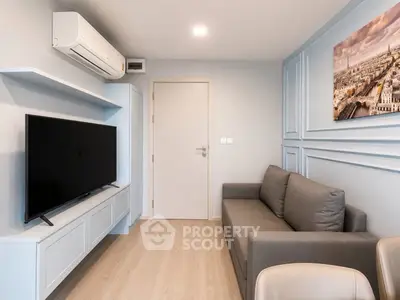 Modern living room with sleek design, featuring a wall-mounted TV, air conditioning, and stylish decor.