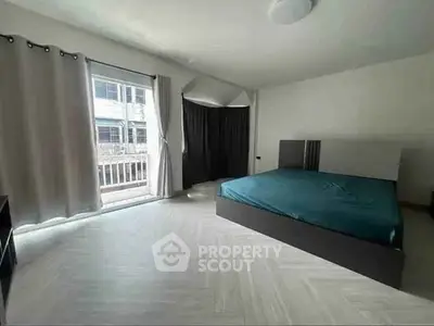 Spacious bedroom with large windows and modern decor