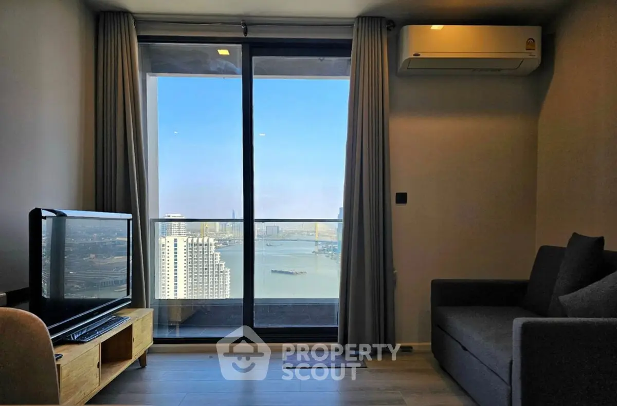 Modern living room with stunning city view from balcony, featuring sleek furniture and air conditioning.