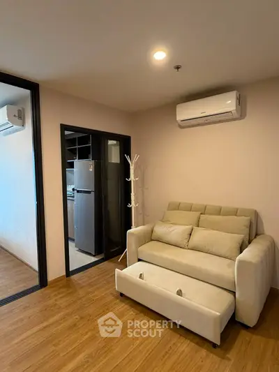 Modern living room with sofa bed and air conditioning in stylish apartment