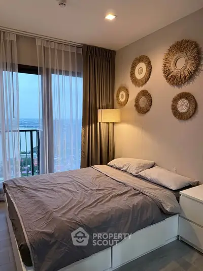 Modern bedroom with stylish decor and large window offering stunning city views.