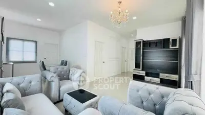Luxurious living room with elegant chandelier and plush seating