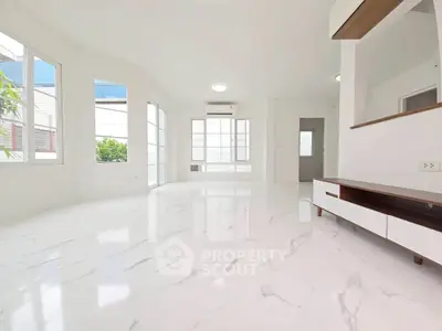 Spacious modern living room with marble flooring and large windows