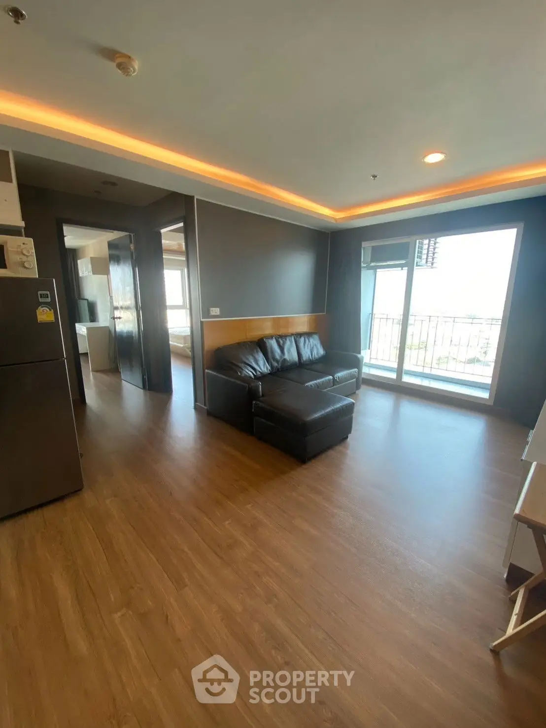 Spacious living room with modern design and large windows offering natural light.