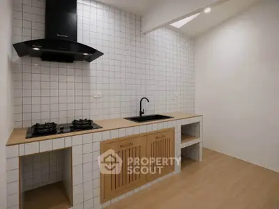 Modern minimalist kitchen with gas stove and sleek cabinetry