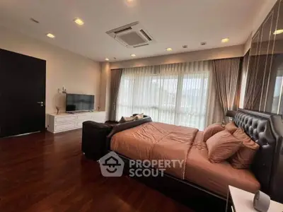 Luxurious bedroom with elegant decor and large windows for natural light