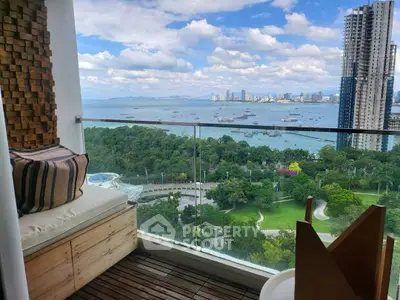 Stunning balcony view overlooking lush greenery and ocean skyline, perfect for relaxation.
