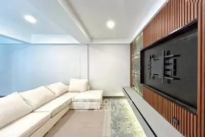 Modern living room with sleek TV mount and cozy sectional sofa