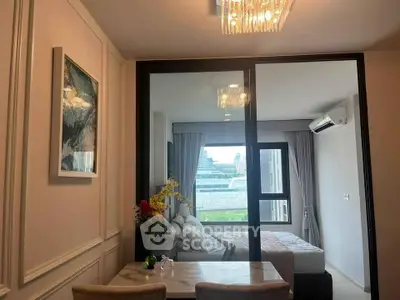 Modern apartment interior with stylish dining area and cozy bedroom view.