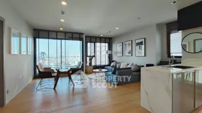 Modern open-plan living room with city view and stylish decor