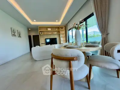 Luxurious modern living room with elegant dining area and large windows offering natural light.