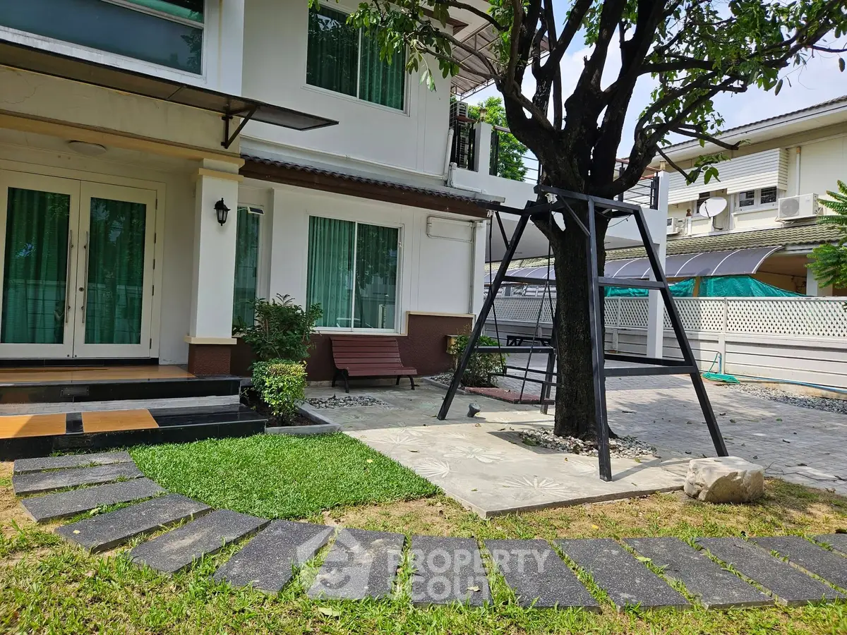 Charming suburban home with lush garden and inviting patio area.